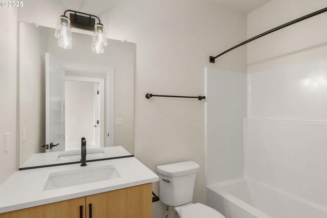 bathroom with shower / washtub combination, vanity, and toilet