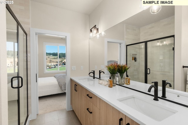 full bathroom featuring a sink, a stall shower, and tile patterned flooring