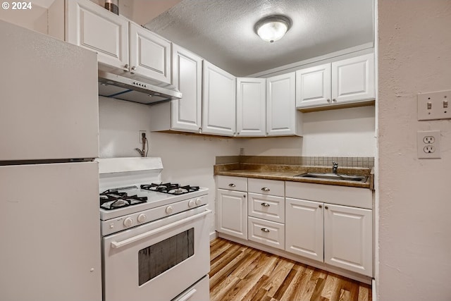 kitchen with sink, light hardwood / wood-style floors, a textured ceiling, white appliances, and white cabinets