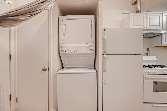 laundry area featuring stacked washer and clothes dryer