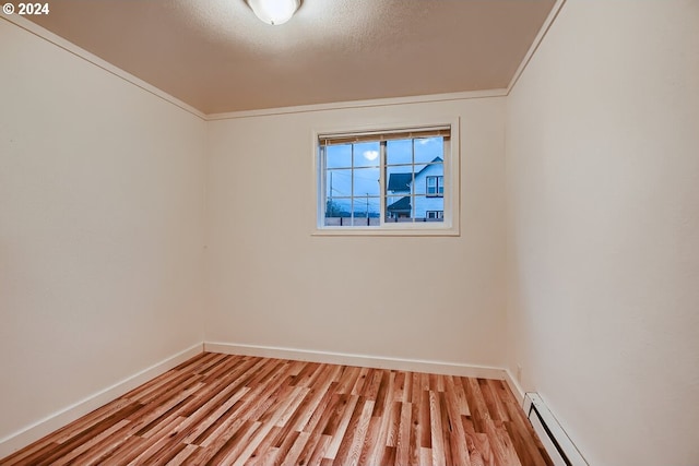 empty room with crown molding, light hardwood / wood-style flooring, a baseboard radiator, and a textured ceiling