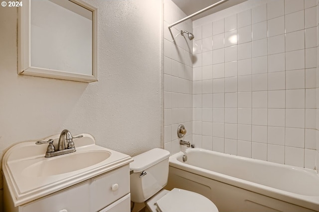 full bathroom with vanity, toilet, and tiled shower / bath