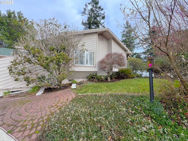 view of property exterior featuring a yard