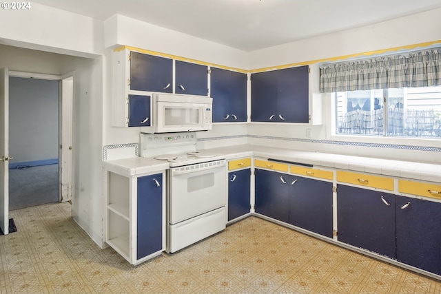 kitchen featuring white appliances and blue cabinets