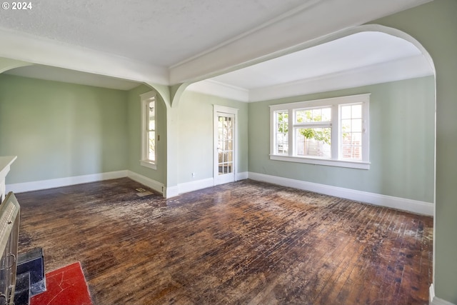 unfurnished living room with dark wood-type flooring