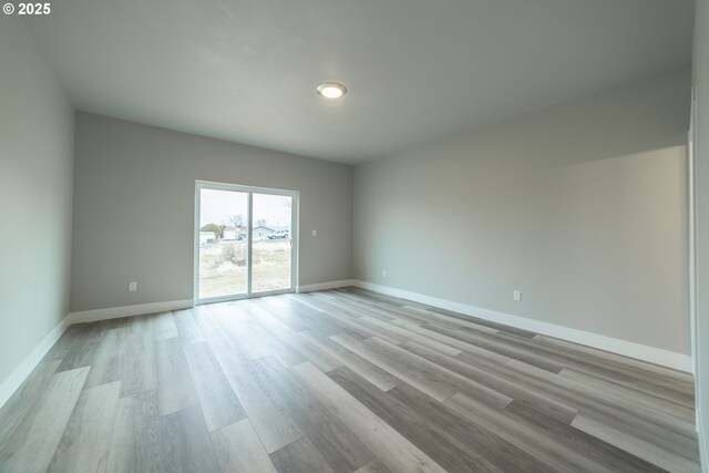 unfurnished room with light hardwood / wood-style floors