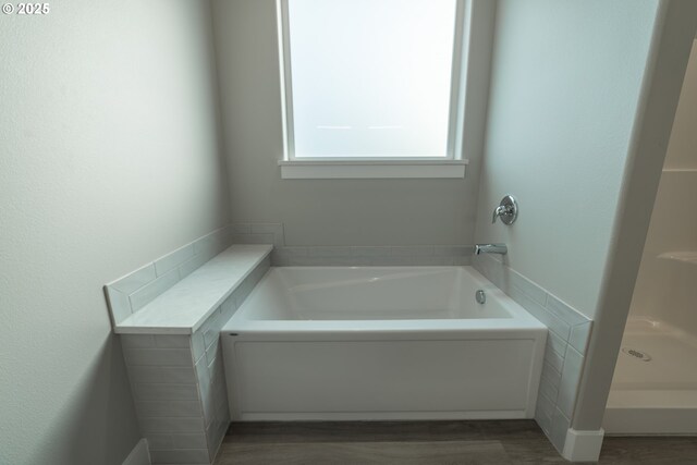 bathroom with a tub to relax in