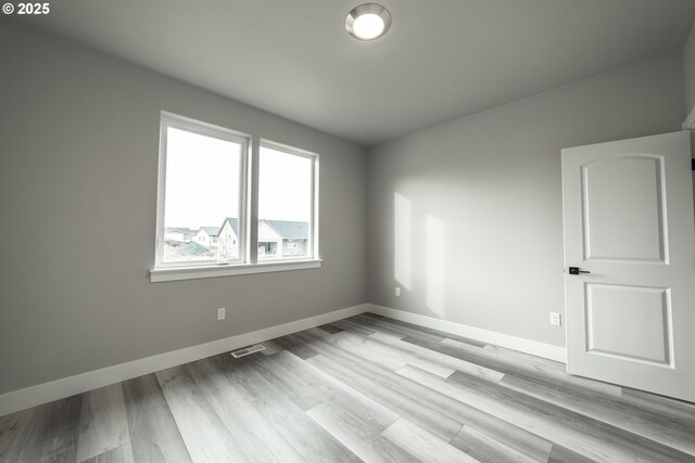 unfurnished room featuring light hardwood / wood-style flooring