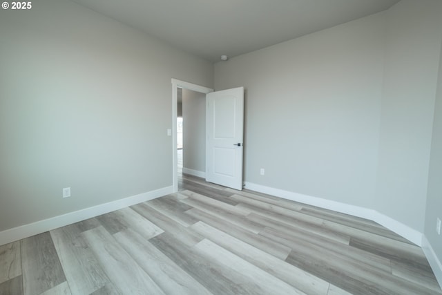 spare room featuring light wood-type flooring