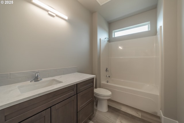 full bathroom with bathing tub / shower combination, vanity, wood-type flooring, and toilet