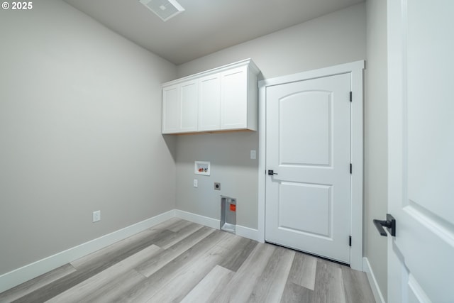 laundry area featuring electric dryer hookup, cabinets, light hardwood / wood-style flooring, and washer hookup