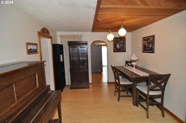 dining room featuring wood ceiling and light hardwood / wood-style floors