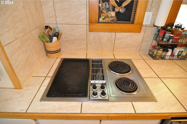 room details with black electric stovetop and backsplash