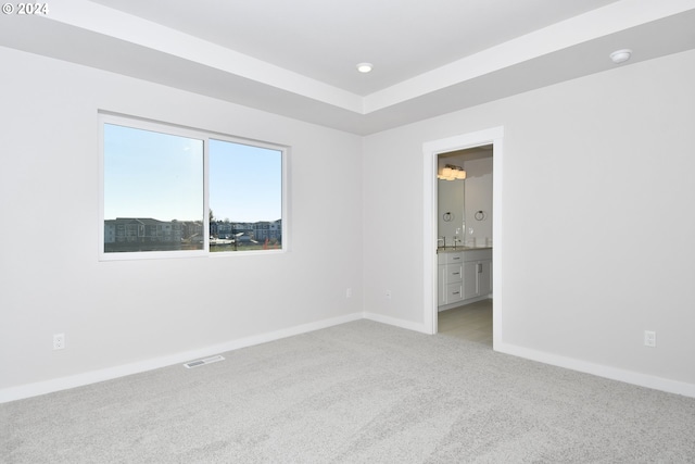 spare room featuring visible vents, baseboards, light carpet, recessed lighting, and a bar