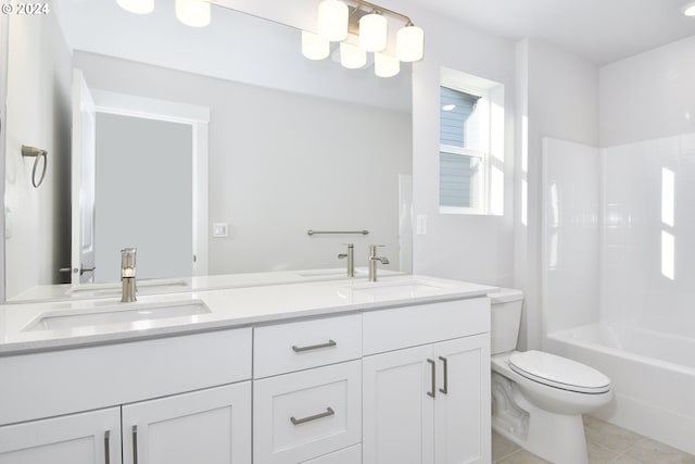 bathroom featuring a sink, toilet, double vanity, and tile patterned floors