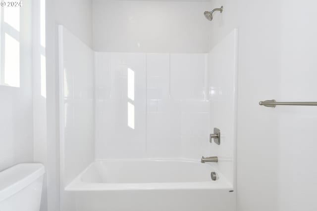 bathroom featuring toilet and shower / bath combination