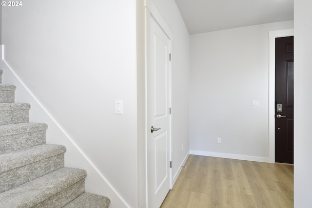 stairs featuring baseboards and wood finished floors