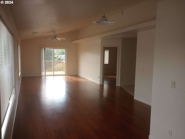 empty room featuring a textured ceiling, dark wood-type flooring, vaulted ceiling, and ceiling fan