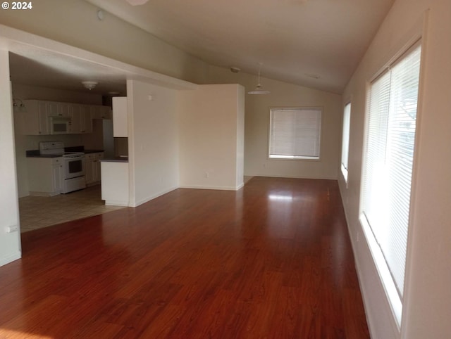 unfurnished living room with lofted ceiling and wood-type flooring