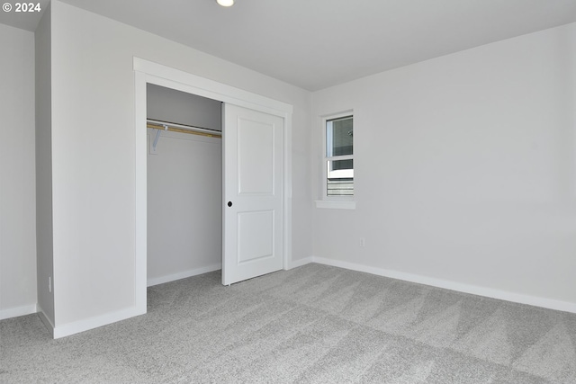 unfurnished bedroom with carpet and a closet