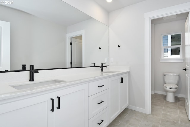 bathroom with tile patterned floors, vanity, and toilet