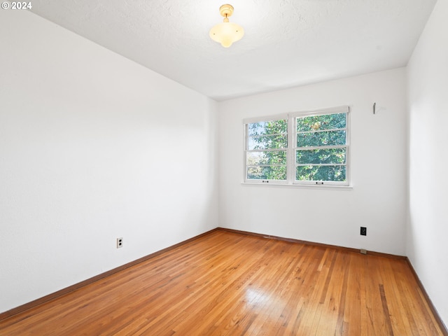 empty room featuring hardwood / wood-style flooring