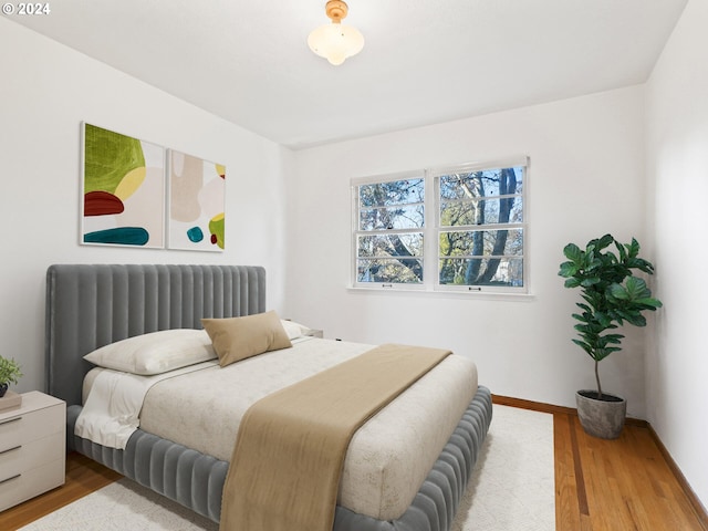 bedroom with light wood-type flooring and radiator