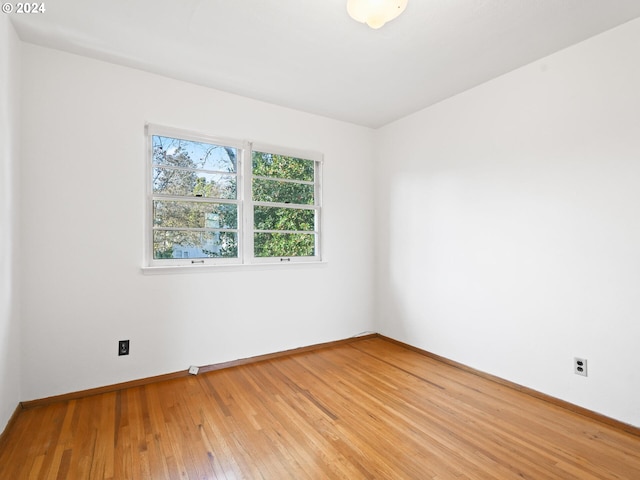 unfurnished room with hardwood / wood-style floors