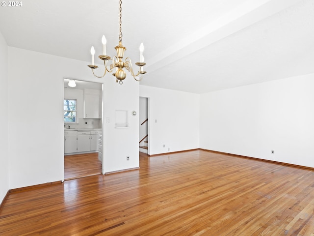 interior space with hardwood / wood-style flooring, an inviting chandelier, and sink