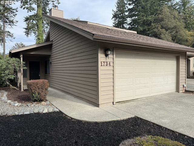 view of side of property with a garage