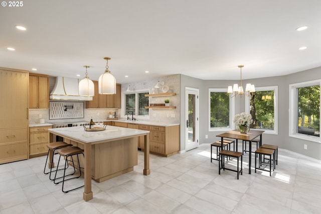 33280 NE Haugen Rd, Newberg, OR 97132 - kitchen featuring custom exhaust hood, open shelves, decorative backsplash, a breakfast bar area, and recessed lighting