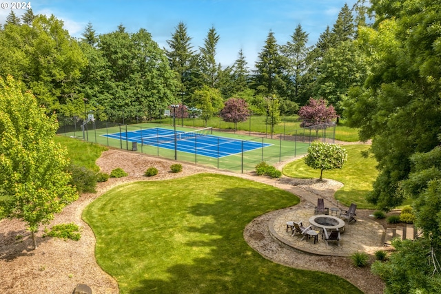 view of sport court featuring a lawn