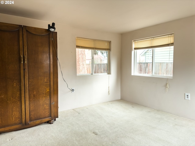 unfurnished bedroom featuring light carpet