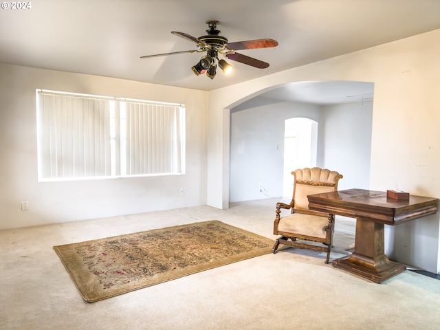 living area featuring ceiling fan and light carpet