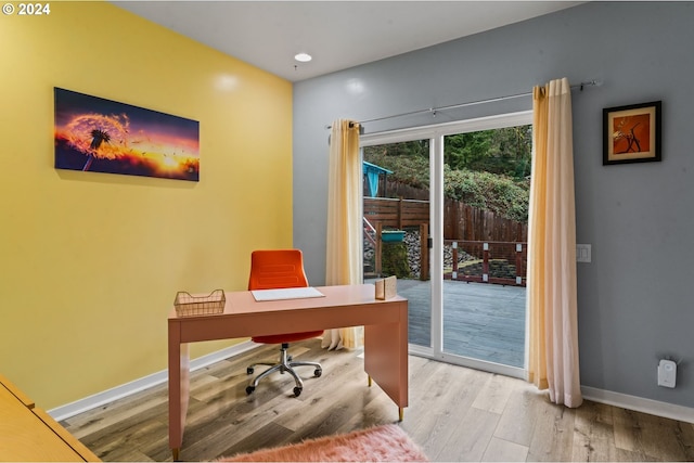 home office with light hardwood / wood-style floors