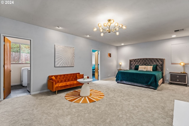 bedroom with ensuite bathroom, light colored carpet, and a notable chandelier