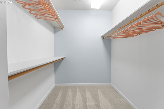 walk in closet featuring carpet flooring