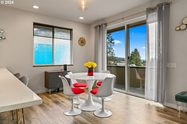 dining space with light hardwood / wood-style flooring