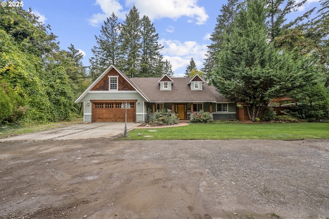 view of front of house featuring a porch, a garage, and a front lawn