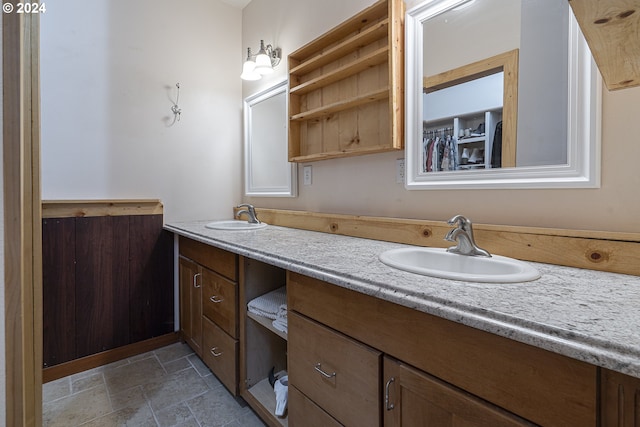 bathroom featuring walk in shower and vanity