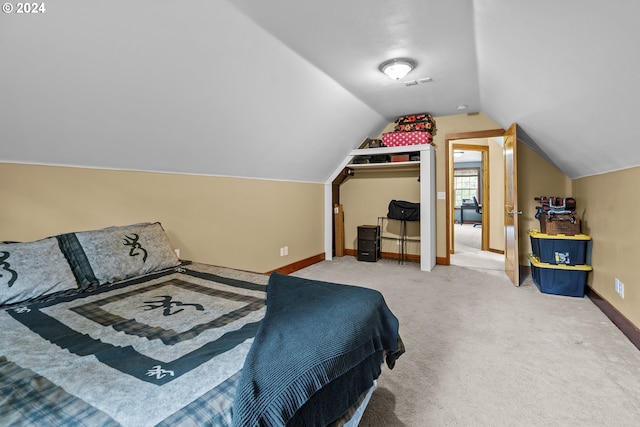 bedroom with vaulted ceiling and carpet floors