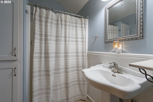 laundry room with a textured ceiling, washer and dryer, and cabinets