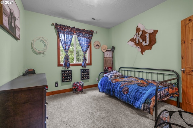 bedroom featuring carpet floors and a textured ceiling