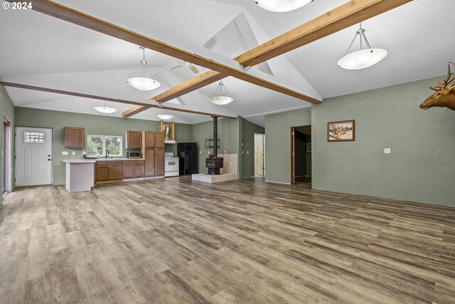 unfurnished living room featuring lofted ceiling with beams, ceiling fan, and hardwood / wood-style flooring