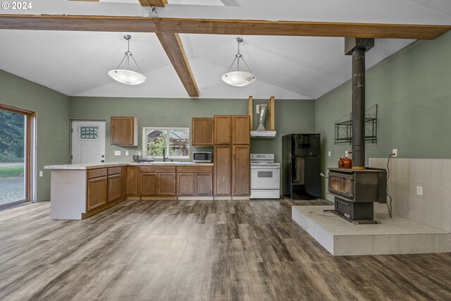 kitchen with pendant lighting, white appliances, a wood stove, lofted ceiling with beams, and dark hardwood / wood-style flooring