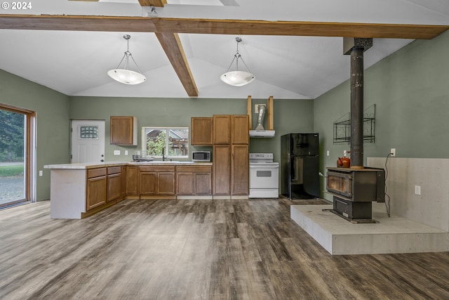 kitchen with black refrigerator, decorative light fixtures, a wood stove, and white range with electric cooktop