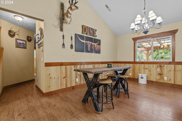 kitchen with light wood-type flooring, stainless steel appliances, a wood stove, sink, and backsplash