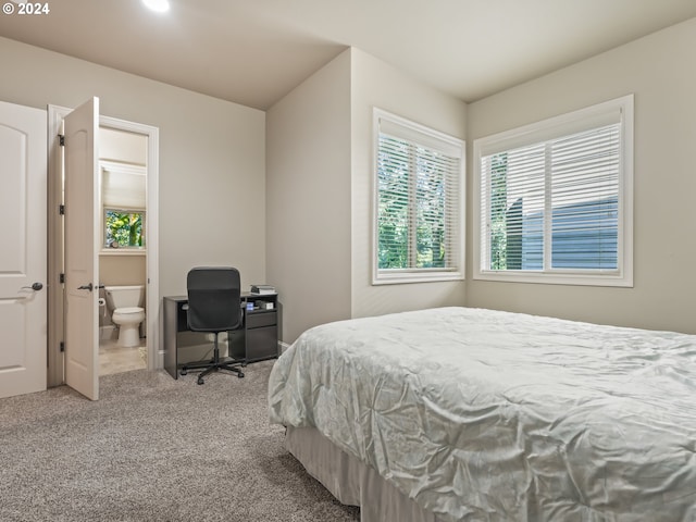 carpeted bedroom featuring ensuite bathroom