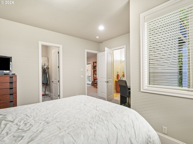 carpeted bedroom featuring ensuite bath