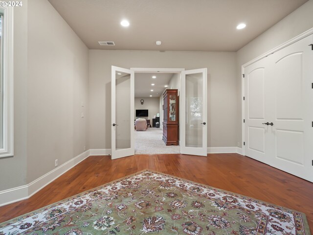 foyer featuring french doors and wood-type flooring